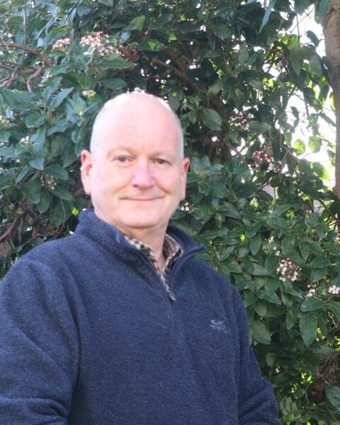Geoff in front of a bush